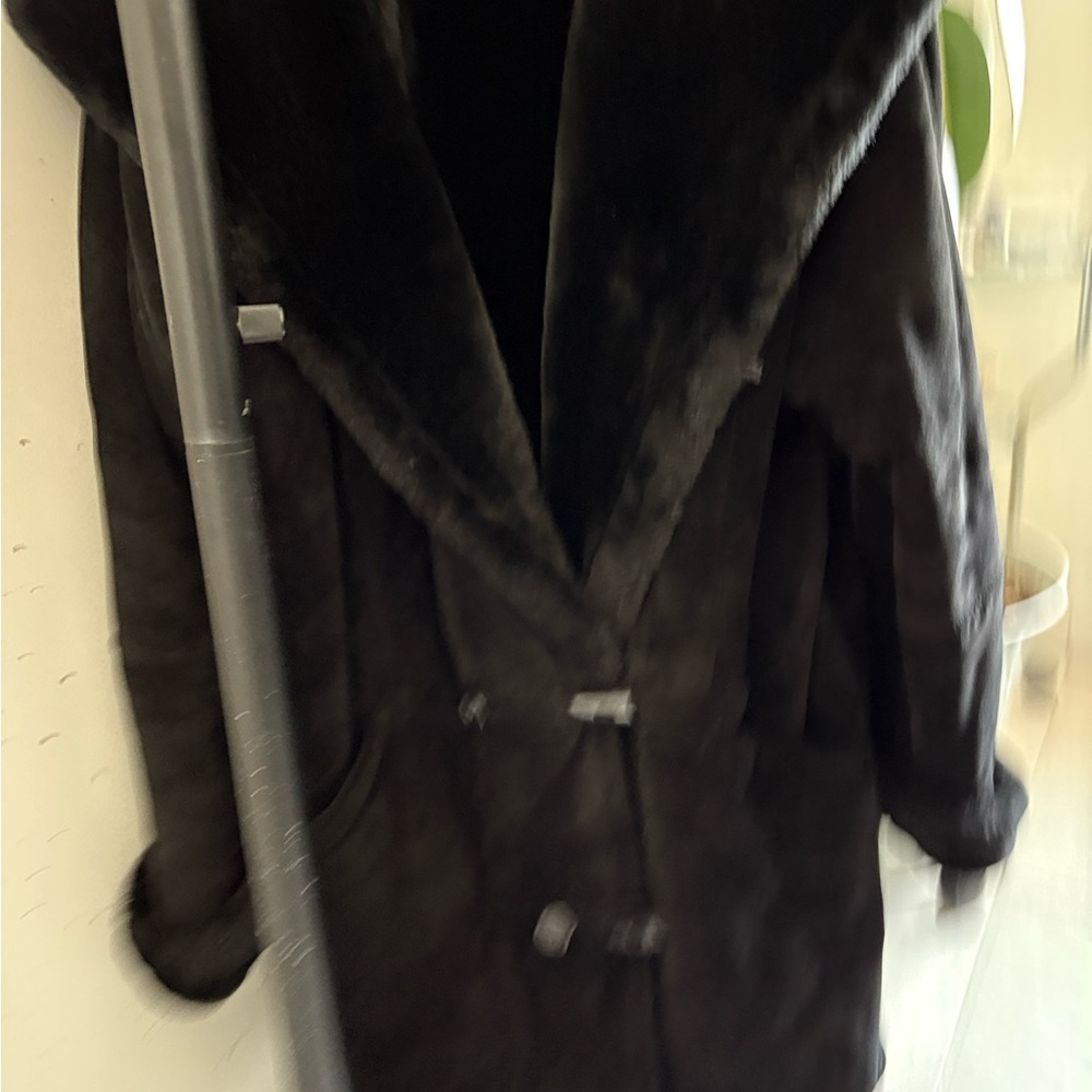 An elegant   black sherling with fur trim. Never been worn , veryy light weight